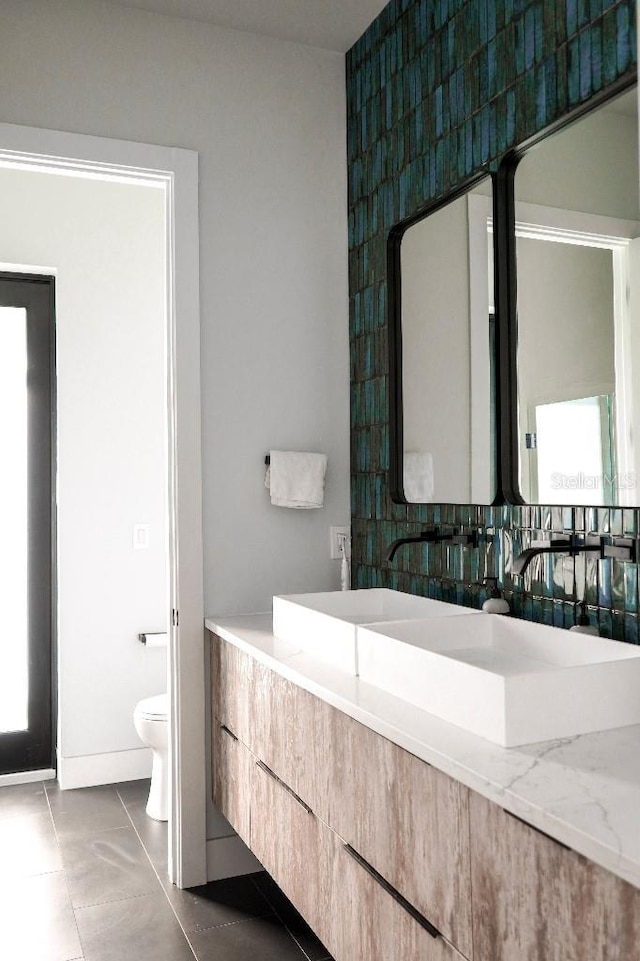 bathroom with vanity, toilet, and tile patterned floors