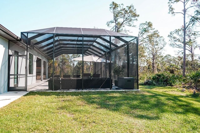 exterior space featuring glass enclosure, a patio, and a detached carport