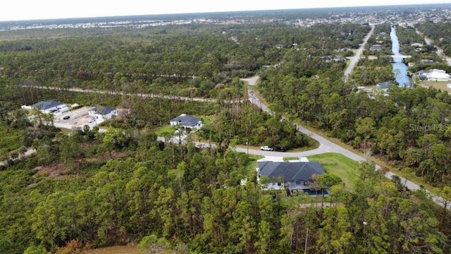 bird's eye view featuring a wooded view