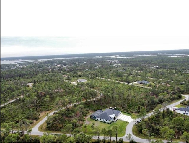 birds eye view of property featuring a wooded view