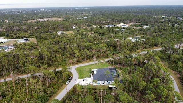 birds eye view of property featuring a view of trees