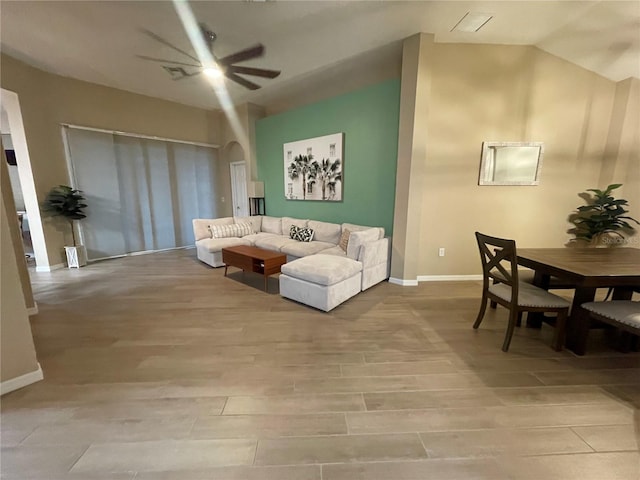 living room with ceiling fan and light hardwood / wood-style flooring