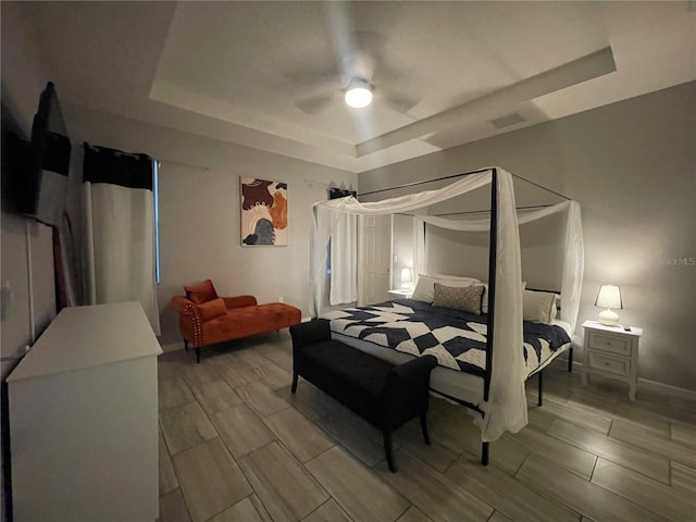 bedroom featuring a tray ceiling and ceiling fan