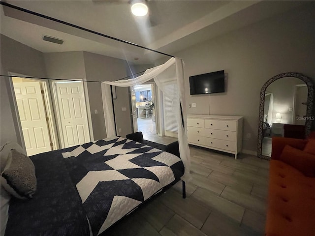 bedroom featuring ceiling fan and multiple closets