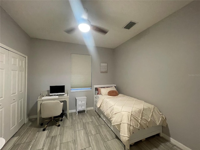 bedroom with ceiling fan and a closet