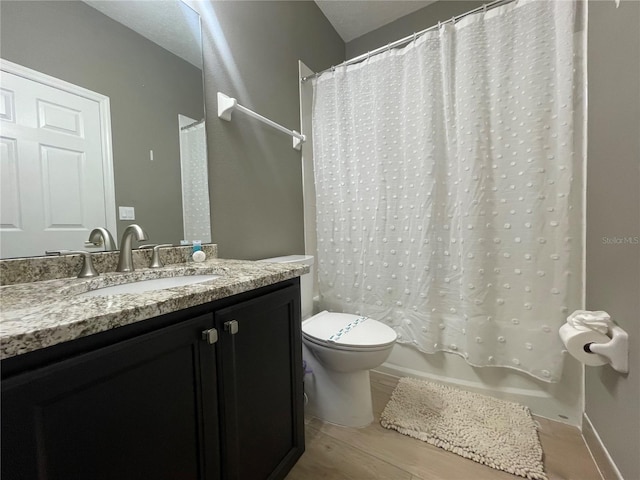 full bathroom with hardwood / wood-style flooring, vanity, toilet, and shower / bathtub combination with curtain