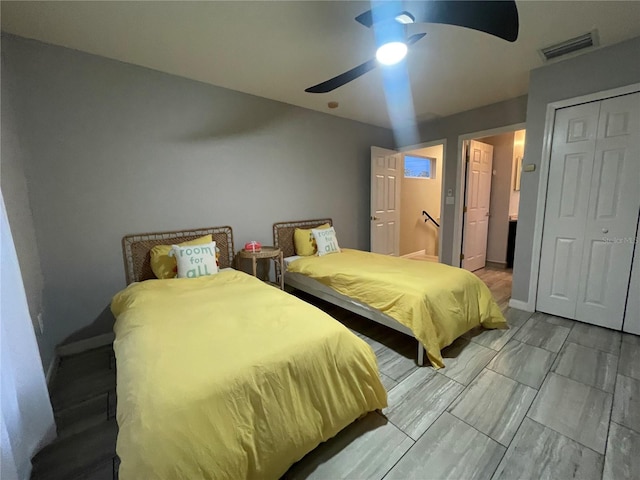 bedroom with ceiling fan and a closet