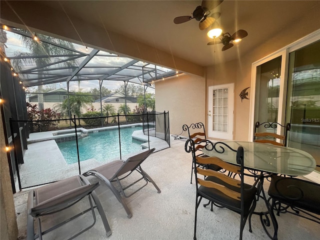 view of pool featuring glass enclosure, ceiling fan, and a patio