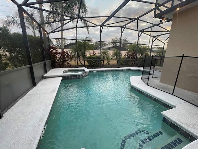 view of swimming pool with a lanai and an in ground hot tub