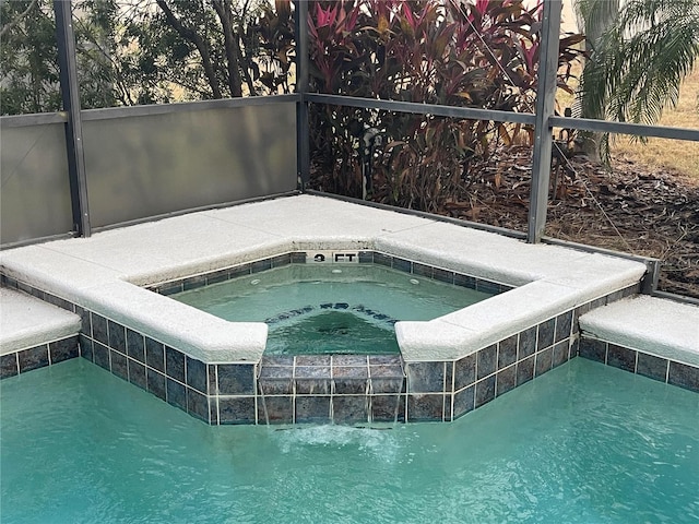 view of swimming pool featuring an in ground hot tub