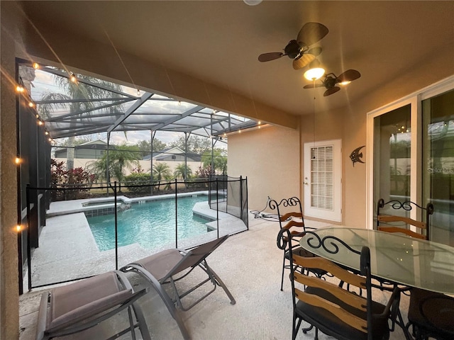 view of pool featuring glass enclosure, ceiling fan, and a patio