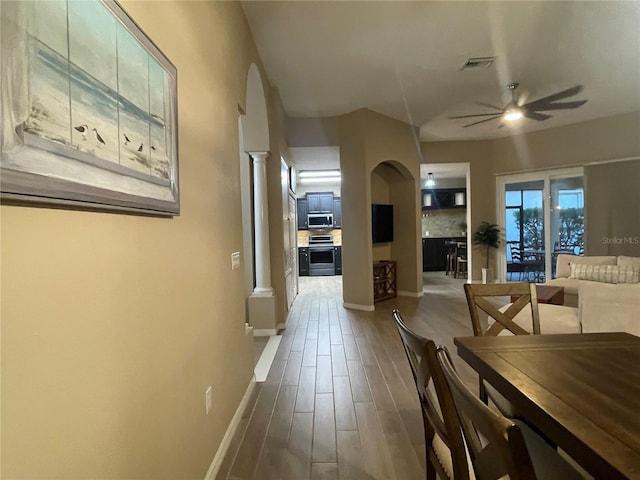 dining space with wood-type flooring and ceiling fan