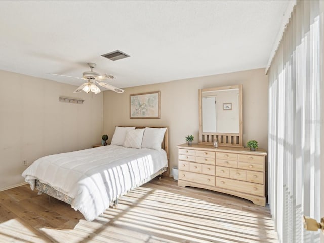 bedroom with light hardwood / wood-style floors and ceiling fan