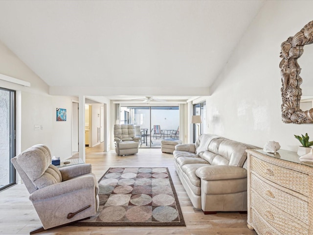 living room with light wood-type flooring, ceiling fan, and lofted ceiling