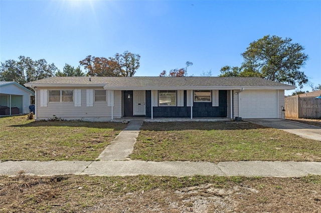 ranch-style home with a garage and a front lawn