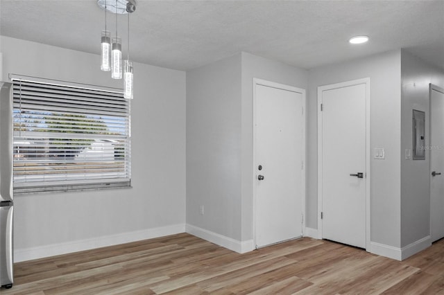 interior space featuring a textured ceiling and light hardwood / wood-style floors