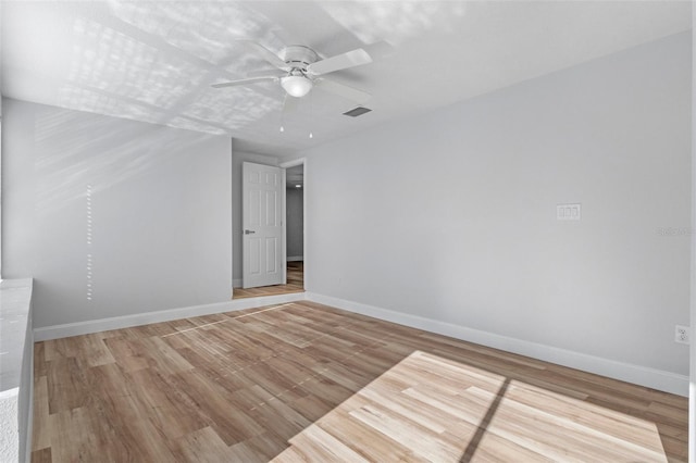 spare room featuring ceiling fan and light hardwood / wood-style flooring