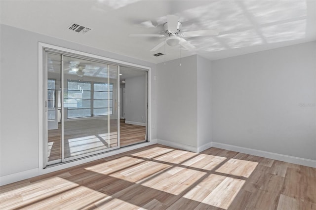 spare room featuring light hardwood / wood-style floors and ceiling fan