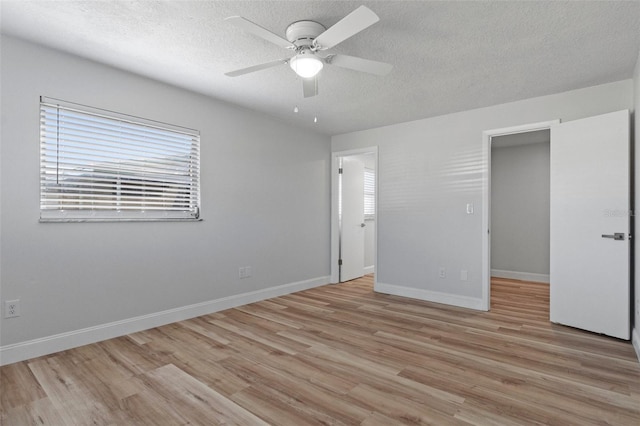 unfurnished bedroom with ceiling fan, light hardwood / wood-style floors, and a textured ceiling