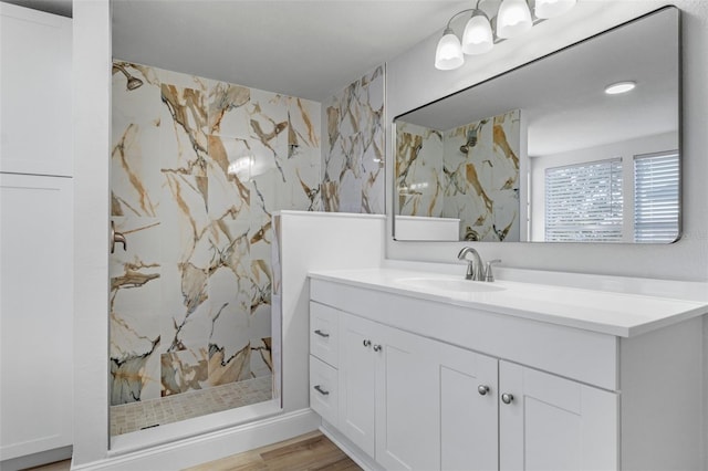 bathroom featuring a shower, hardwood / wood-style floors, and vanity