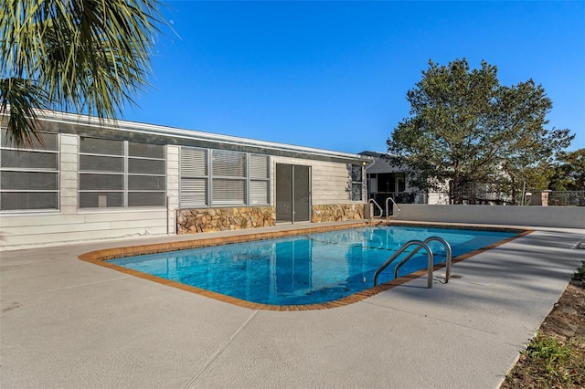 view of swimming pool with a patio