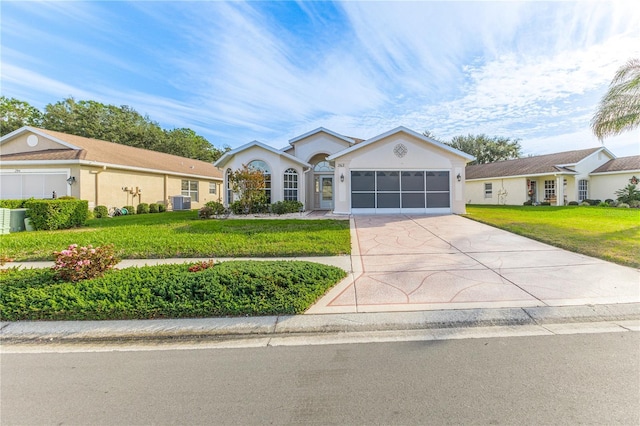 ranch-style house with a garage and a front lawn