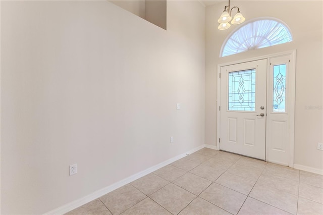 foyer entrance featuring light tile patterned floors and a notable chandelier