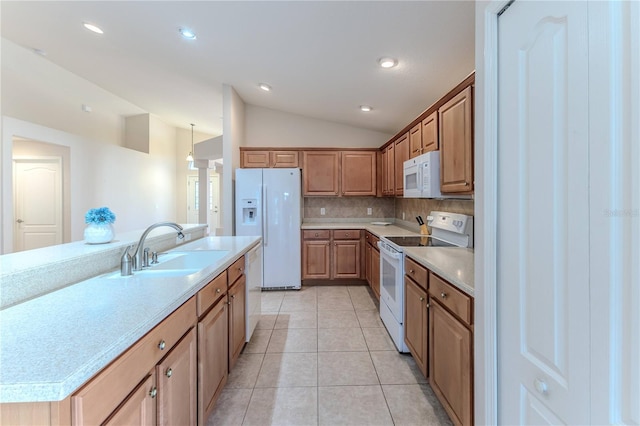 kitchen with white appliances, sink, vaulted ceiling, light tile patterned floors, and tasteful backsplash