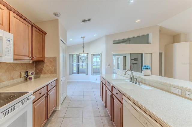 kitchen with hanging light fixtures, white appliances, vaulted ceiling, decorative backsplash, and light tile patterned floors