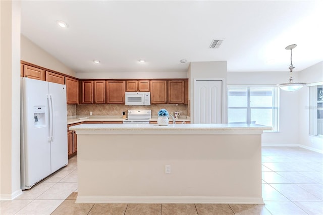 kitchen featuring pendant lighting, white appliances, decorative backsplash, light tile patterned floors, and an island with sink