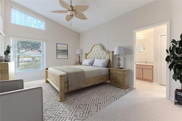 carpeted bedroom featuring ceiling fan, sink, ensuite bathroom, and vaulted ceiling