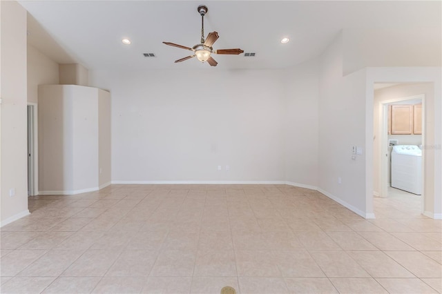 tiled spare room with washer / clothes dryer and ceiling fan