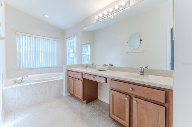 bathroom with tile patterned flooring, vanity, a relaxing tiled tub, and vaulted ceiling