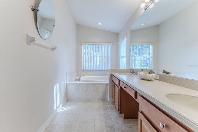 bathroom featuring tile patterned flooring, vanity, lofted ceiling, and tiled tub