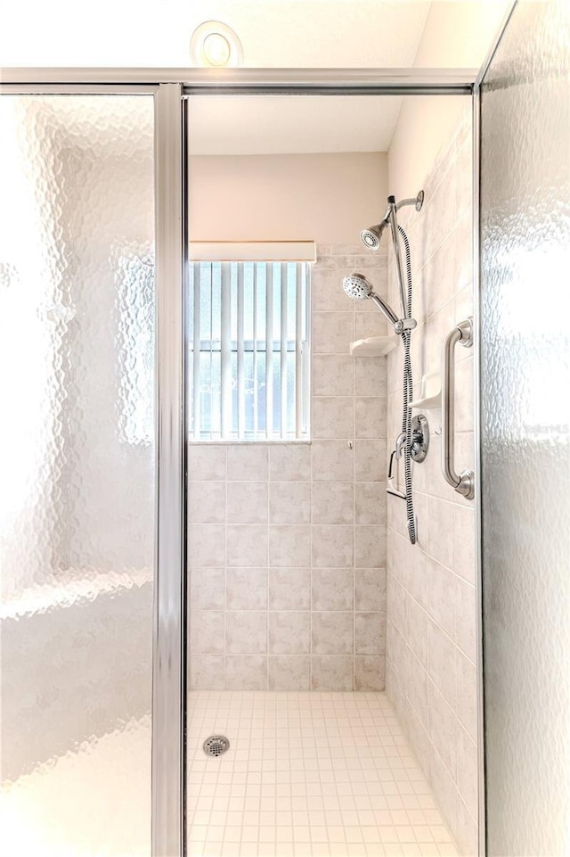 bathroom with a shower with door