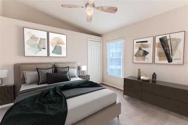 bedroom featuring ceiling fan, a closet, light carpet, and vaulted ceiling