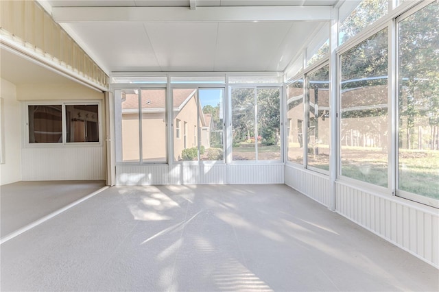 unfurnished sunroom featuring plenty of natural light and vaulted ceiling