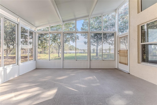 unfurnished sunroom with plenty of natural light and vaulted ceiling