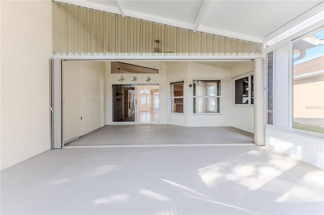 unfurnished sunroom with lofted ceiling