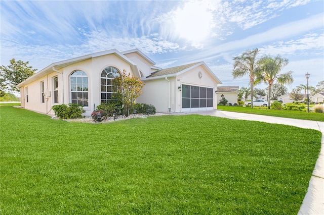 view of front of house featuring a front yard and a garage