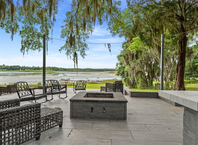 view of patio featuring a water view and an outdoor fire pit