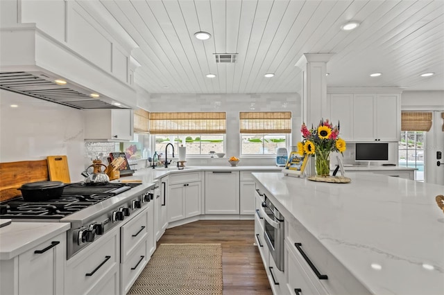 kitchen with white cabinetry, wooden ceiling, sink, and stainless steel gas cooktop