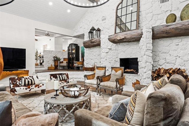 interior space with a stone fireplace, wood ceiling, and high vaulted ceiling