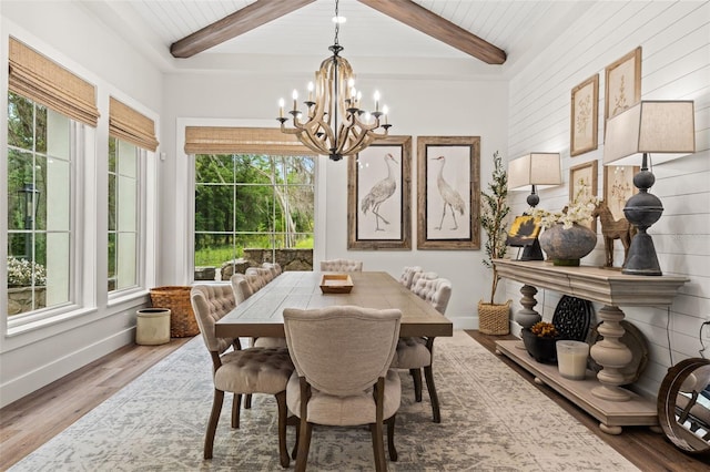 dining space featuring beamed ceiling, wood ceiling, hardwood / wood-style floors, and a chandelier