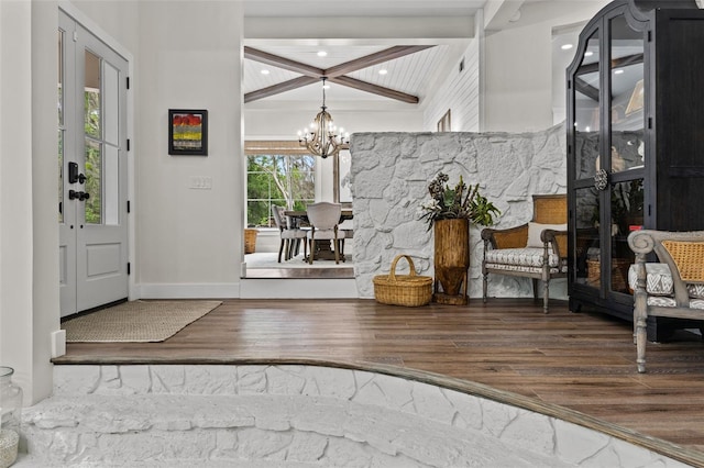 foyer entrance with beamed ceiling, a notable chandelier, and dark hardwood / wood-style flooring