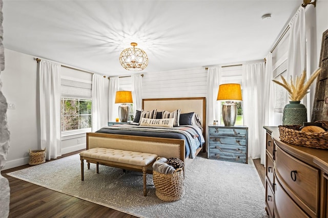 bedroom with a chandelier and hardwood / wood-style flooring