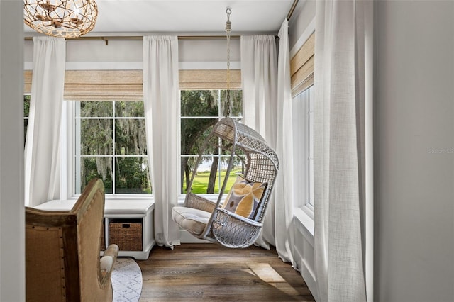 sunroom featuring a chandelier