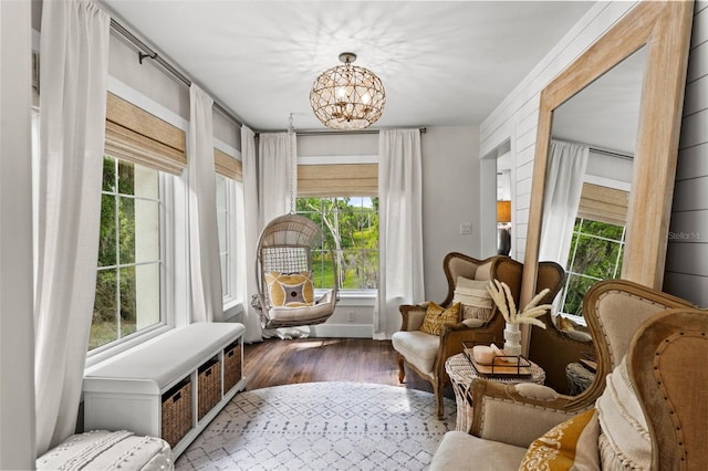 sitting room featuring hardwood / wood-style floors, plenty of natural light, and a notable chandelier