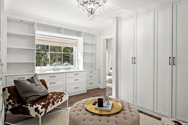 sitting room featuring a chandelier and hardwood / wood-style flooring