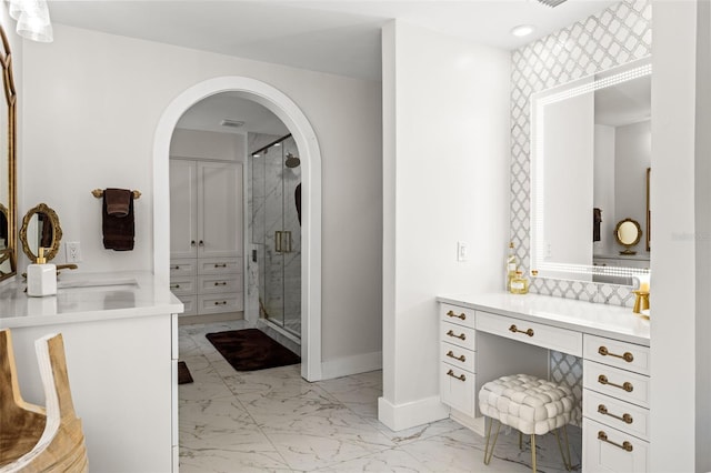 bathroom featuring vanity and an enclosed shower